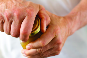 Strong Male Hands Twisting a Stubborn Jar Lid